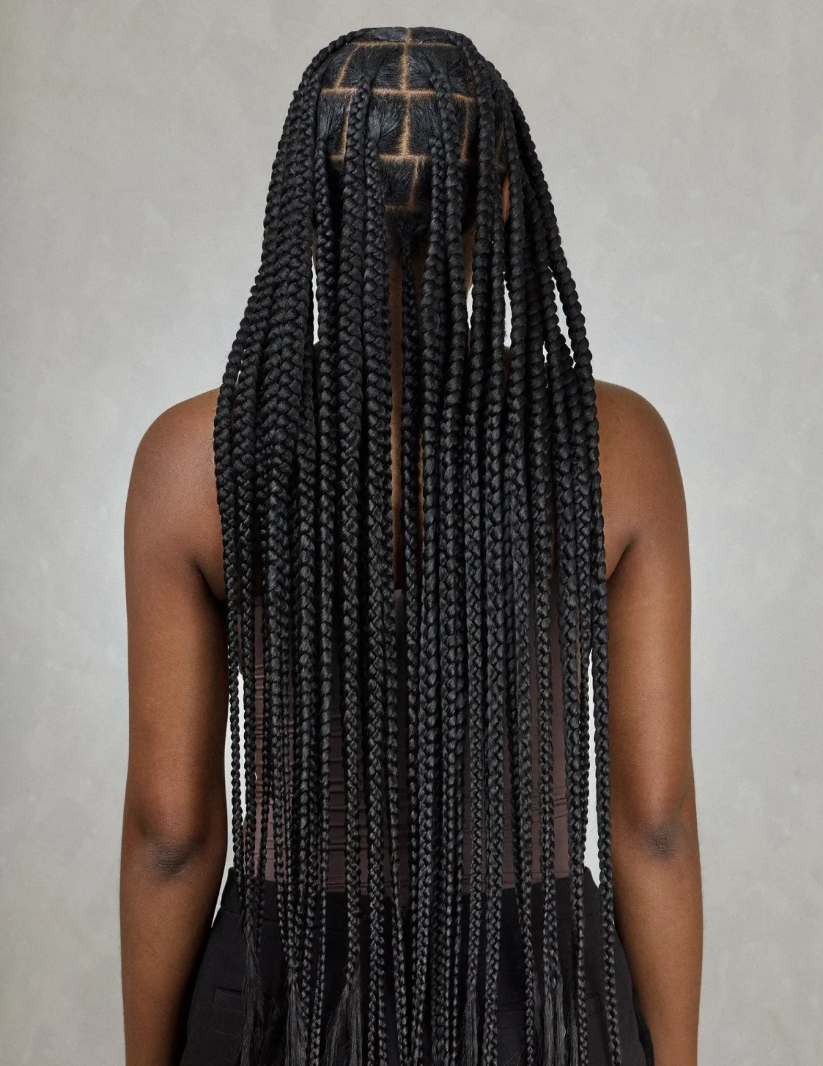 Long knotless box braids styled down the back, installed at The Braiders Lounge in North Brunswick, NJ.