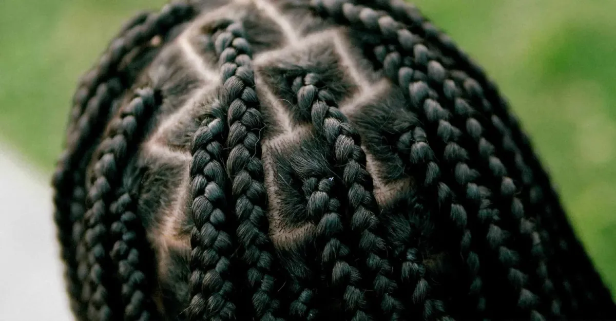 Close up of clean, geometric stitch feed in braids with crisp parts on a client at The Braiders Lounge.